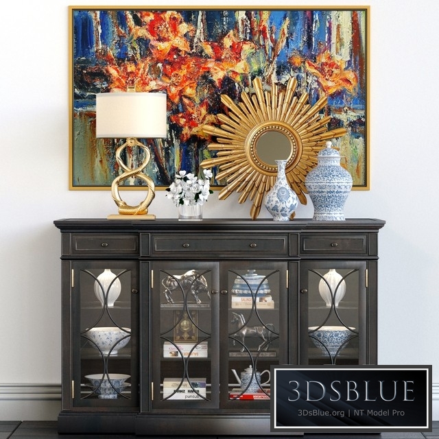 A chest of drawers with a collection of decor, a lamp and a set of sculptures